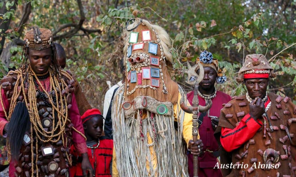 dozo hunters in the forest with a mask and waistcoats full of gri-gri