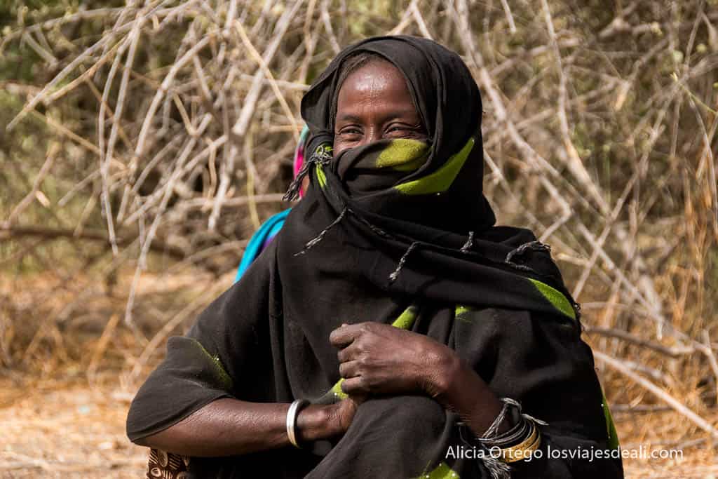 Kanembou woman with veil covering her face and smiling